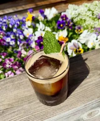 Enjoy this sunshine with our featured cocktail: The Midnight Shift . A perfectly uplifting blend of Tequila, Mezcal, Licor 43, Espresso Liqueur, Cold Brew, Orange Oils, and Mint. 💚