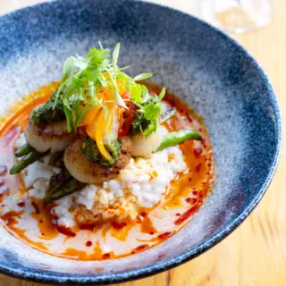 Our Thai red curry scallops are the perfect flavorful and bright dish on these sunny and crisp evenings. A perfect blend of scallops, coconut lime risotto, chile green beans, thai pesto, pickled peppers, and cilantro. Enjoy with a handcrafted cocktail (or two!)